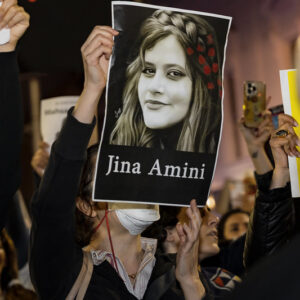 poster held by women in iran protest