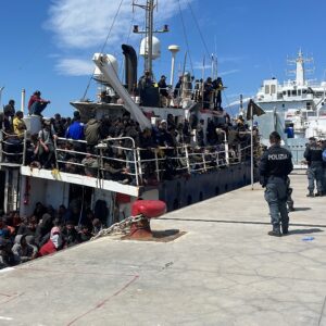 Catania,Sicily,Italy,April 12,2023, a large boat with about 500 migrants landed in the port. The boat was towed by the Italian authorities into the port on 2023