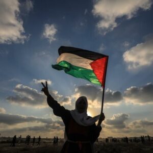 Woman holding the Palestinian flag.