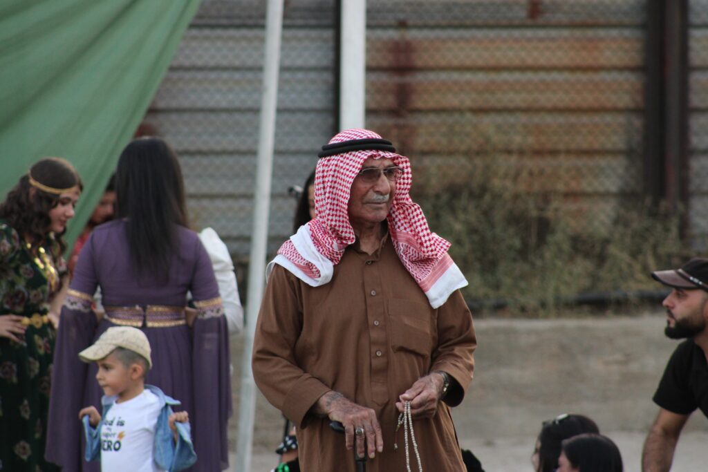 Photo 3: An Arab man at a celebration of the revolution in Qamishli, 2023. Photo by Anna Rebrii