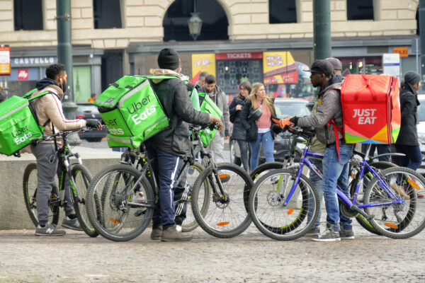 Group of food delivery couriers working in the gig economy.