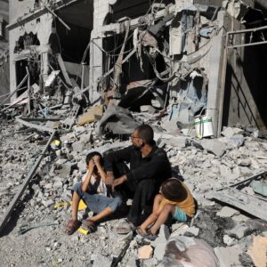 Palestinians search a house after an Israeli air strike, in the city of Rafah, south of the Gaza Strip, on October 12 2023.