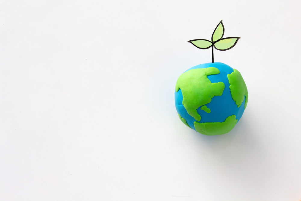 Planting tree in green globe , Environment conservation ,CSR Abbreviation or Corporate Social Responsibility