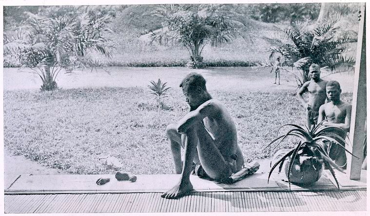 Original caption: NSALA OF WALA IN THE NSONGO DISTRICT (ABIR CONCESSION) (Photographed by Mr. John H. Harris in May, 1904, with the hand and foot of his little girl of five years old—all that remained of a cannibal feast by armed rubber sentries. The sentries killed his wife, his daughter, and a son, cutting up the bodies, cooking and eating them. See letter from Mr. Stannard in the Appendix.)