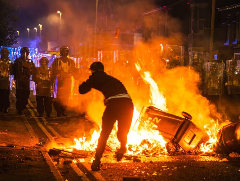 Southport, merseyside, UK, July 30th 2024, rioter throws brick at police line over fire