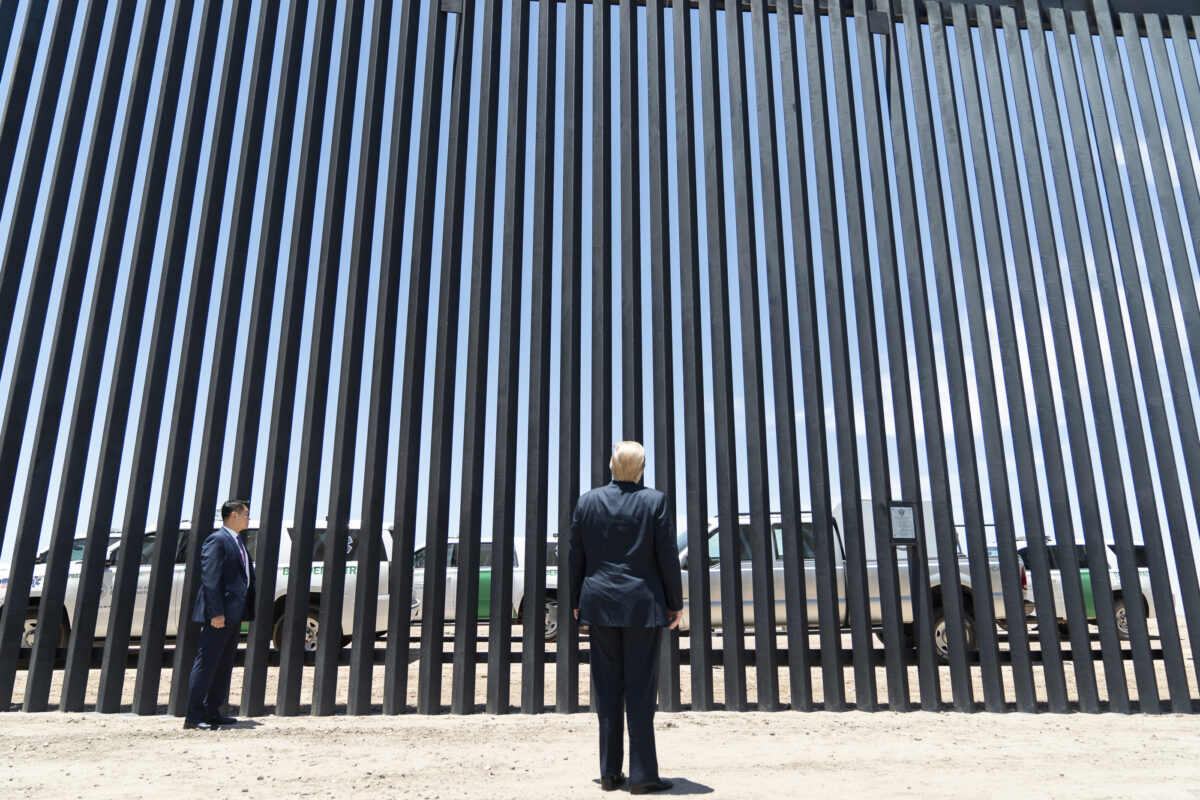 President Donald J. Trump stands before a plaque Tuesday, June 23, 2020, commemorating the 200th mile of new border wall along the U.S.-Mexico border near Yuma, Ariz. (Official White House Photo by Shealah Craighead)