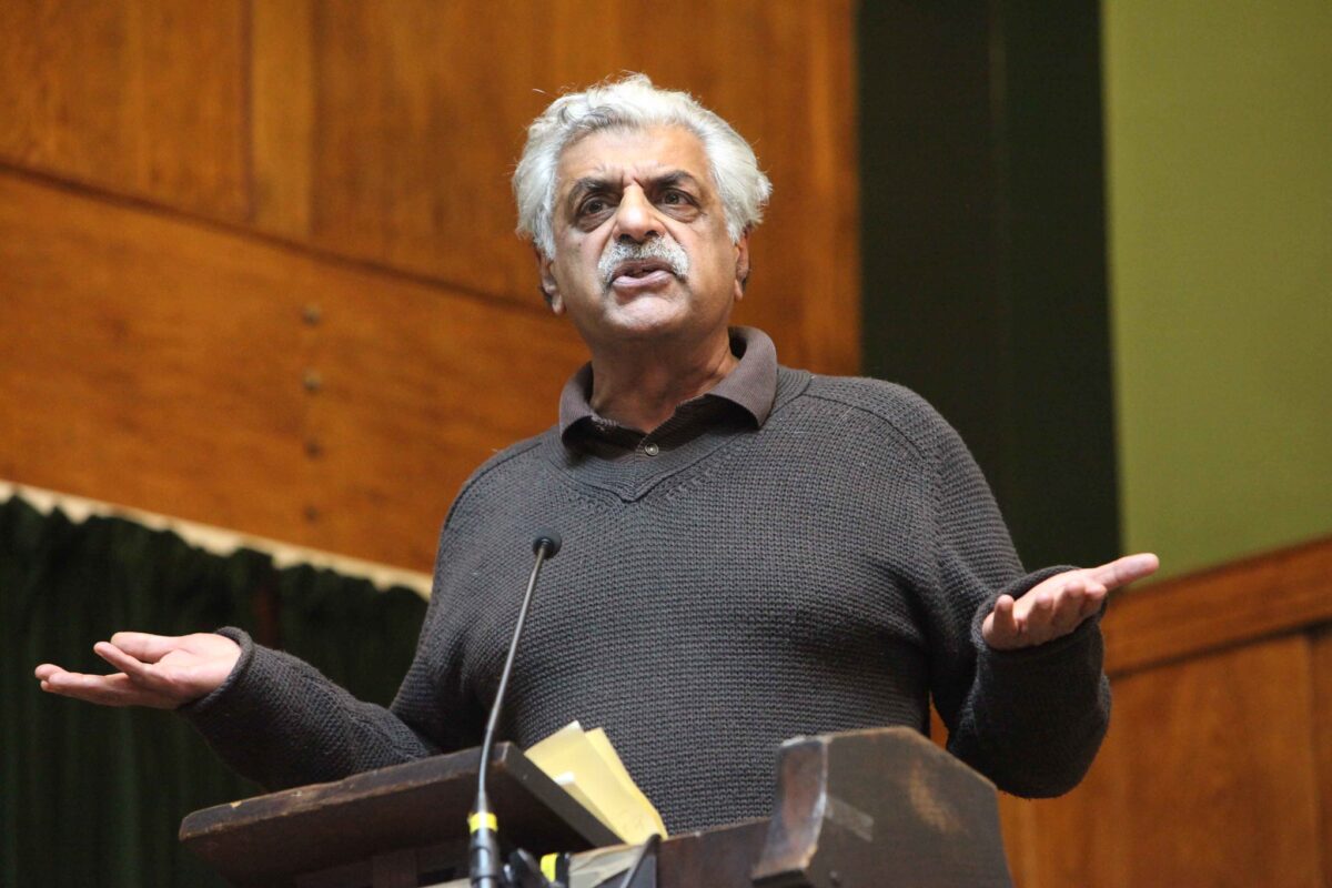 Close up of Tariq Ali speaking at a rostrum