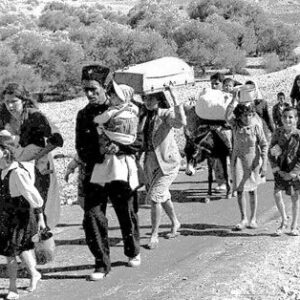 Black and white photo with group of people tramping towards us carrying children and possessions displaced Palestiian refugees fleeing during the 1948 Nakba