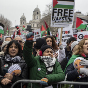 Women at Palestine rally carrying dolls