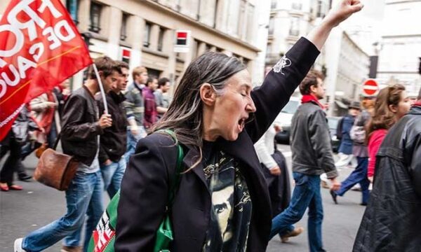 Demonstrators in Turkey with woman with raised arm in forground