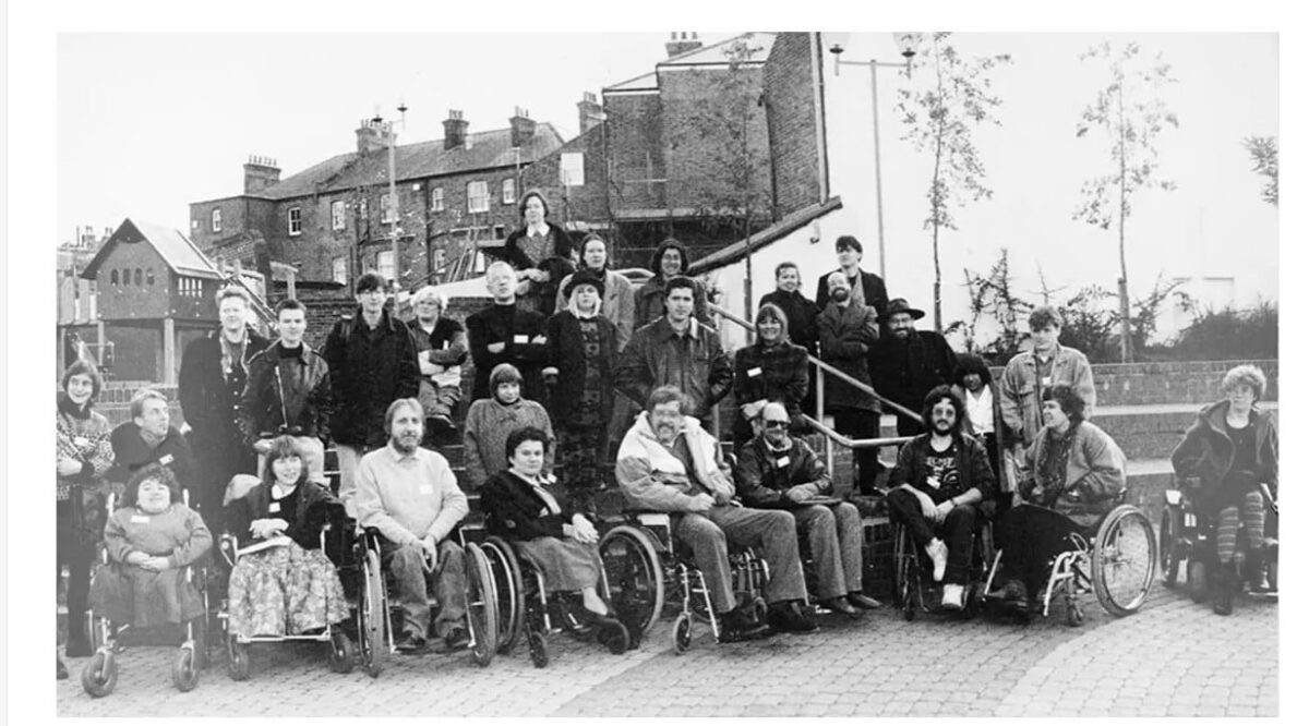 A 1991 black and white photograpj of disability arts performers