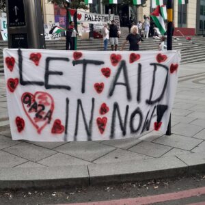 Hand panied banner: Let aId in now' Photo: Tony Foley