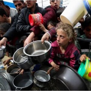 Palestinian refugees assemble with empty bowls and pans.