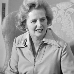 Greyscale image of Thatcher wearing a trench coat