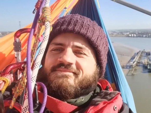 Marcus Decker eco acivist on gantry on M25