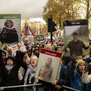 Protestors with placard with photos of three of the hunger strikers on 29 Nov demonstration. Photo: Steve Eason