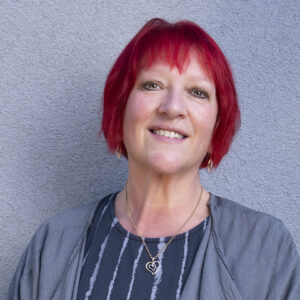 An image of Andrea Egan against a grey background