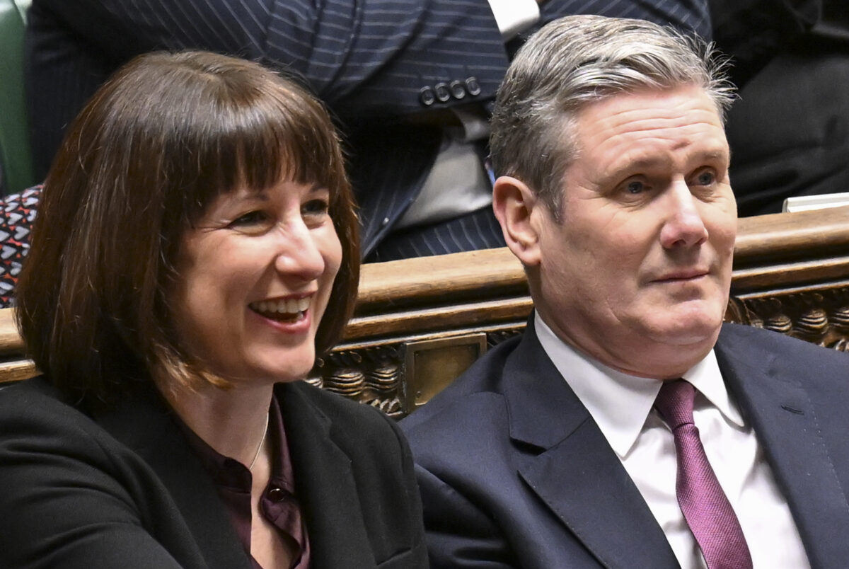 Rachel Reeves and Keir Starmer side by side on green benches in House of Commons