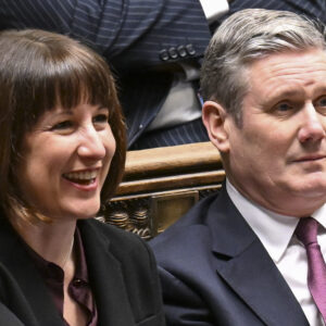 Rachel Reeves and Keir Starmer side by side on green benches in House of Commons
