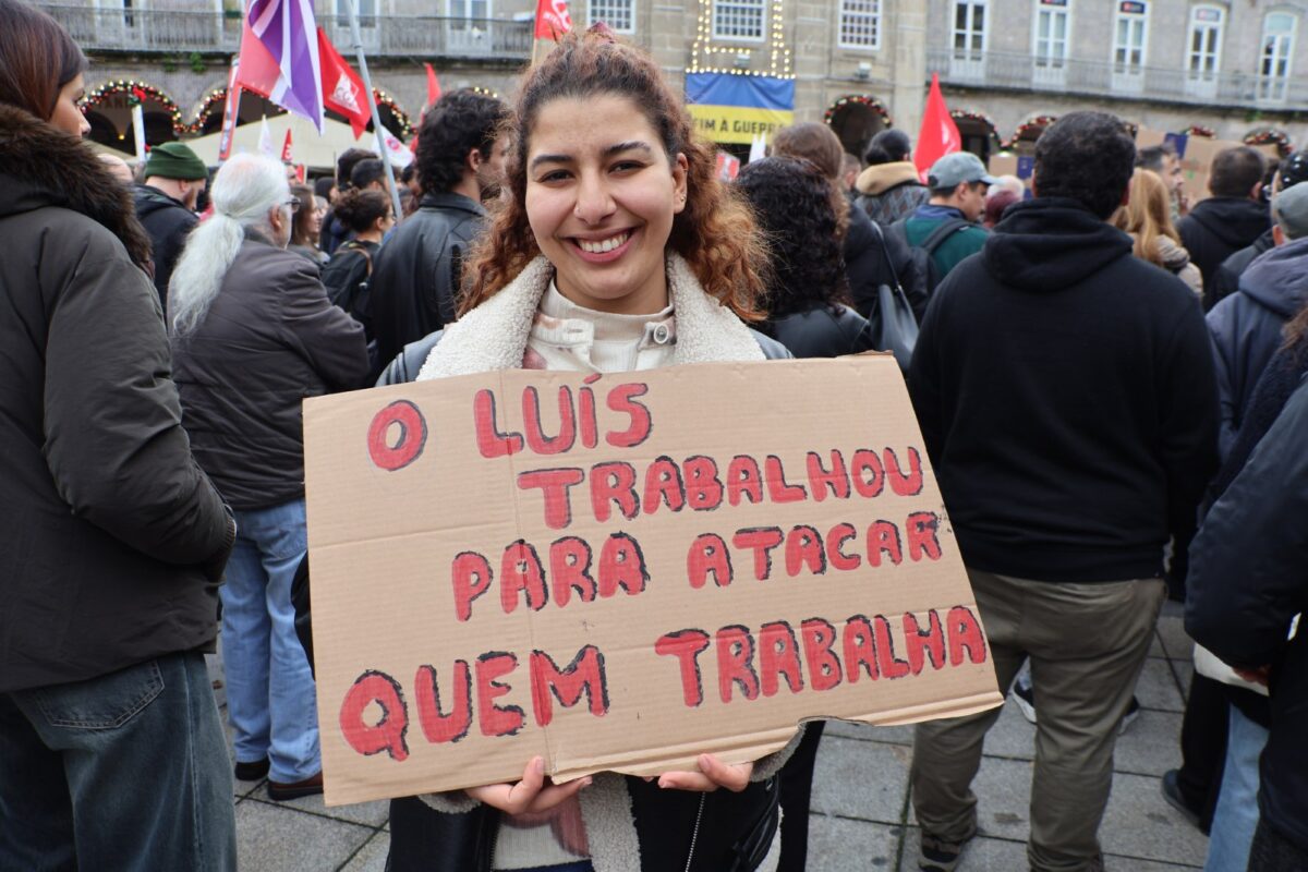 Young woman in Braga portugal holding a cardboard poster