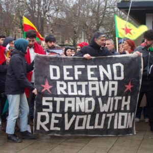 Large bannee: Defend Rojava Stand with Revolution
