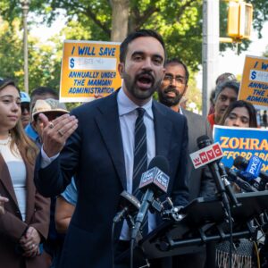 Mamdani with others and posters
