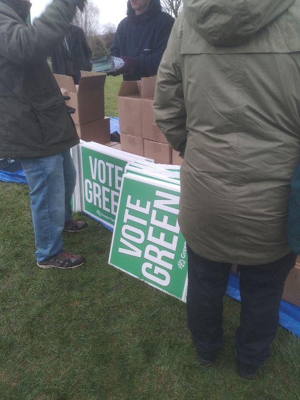 sta;; with placards and boxes supporting Greens in Gorton and Denton byelection