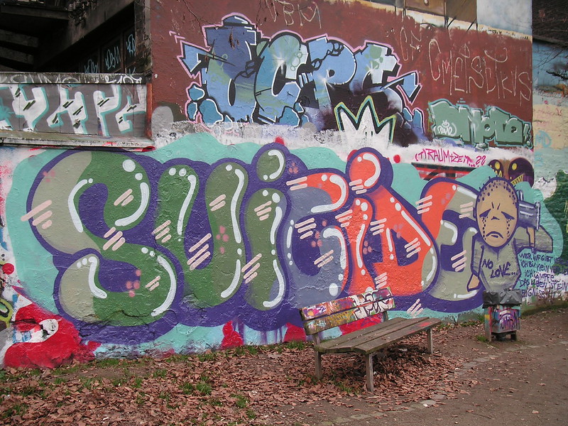 Wall with 'suicide' grafitied in multicoloured letters
