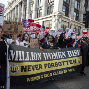 Million women rise: Never forgotten Women and girls murdered by men Black and yellow banner with lettering in white and black