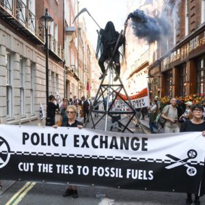 demostration with banner against rightwing think tank, policy exchange