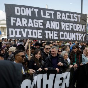 Large black banner with white lettering: Dont ler racisr Daeage and Ewfoen divide the country. Photo: Steve Eason