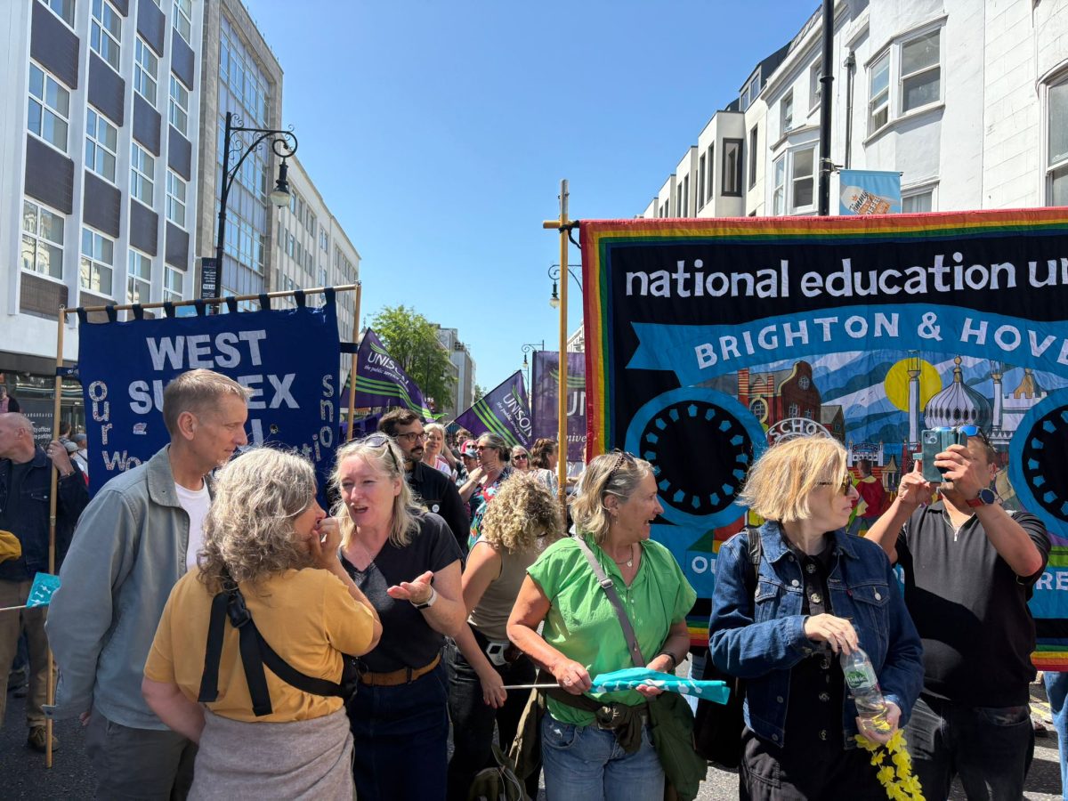 NEU banner amongst crowds. Brighton Carnival v fascism Photo Andy Richards
