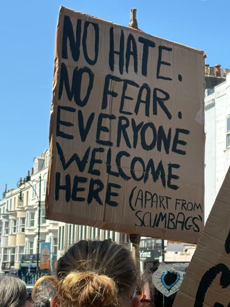 No hate, no fear, everyone welcome here - except scumbags on cardboard placard. Brighton Carnival against Fascism. Photo: Andy Richards