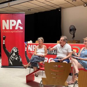 Large vertical banner with NPA in white lettering , person with arm raised in black and white on red background with 3 people sitting on chairs.