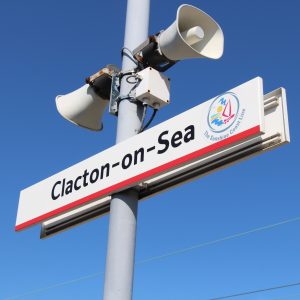 Sign saying Clacton-on-Sea black lettering on white sign with red stripe underneath. Photo: Shutterstock