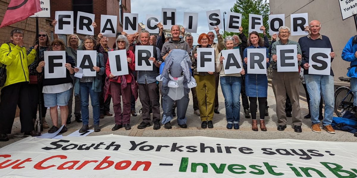 Campaigners holding individual letters spelling out Franchise for fair fares