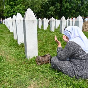 muslim woman praying in Srebrenica cemetry