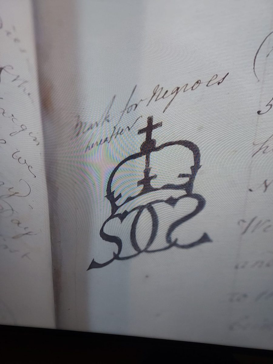 screen shot from tv documentary on British slave traders showing South Sea company brand for slaves