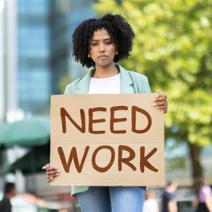 Shutterstock picture of young woman with sign saying need work