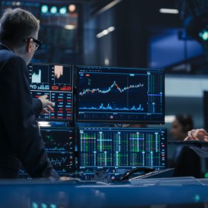 two traders looking at market screens