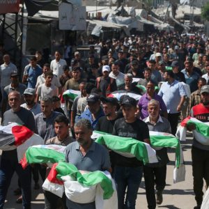 Mourners have bodies to bury. Here they carry the remains of members of three families during a funeral for nearly 100 people, including 70 children, who were killed in Israeli attacks and recovered by Palestinian Civil Defense teams from beneath the rubble in Gaza City’s Zeitoun neighborhood on September 6, 2026. (Yousef Zaanoun/Activestills)