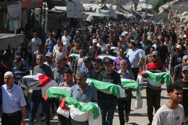 Mourners have bodies to bury. Here they carry the remains of members of three families during a funeral for nearly 100 people, including 70 children, who were killed in Israeli attacks and recovered by Palestinian Civil Defense teams from beneath the rubble in Gaza City’s Zeitoun neighborhood on September 6, 2026. (Yousef Zaanoun/Activestills)
