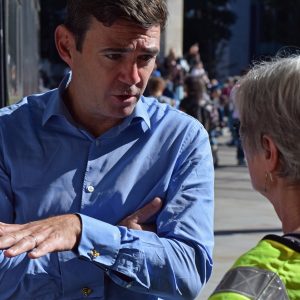 Burnham talking to woman in yellow jacket