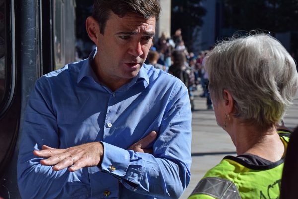 Burnham talking to woman in yellow jacket